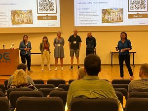 6 presenters standing in front of the audience